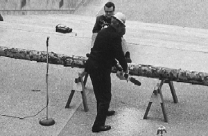 Governor Tom McCall used a chain saw to cut a log, replacing the traditional ribbon-cutting ceremony