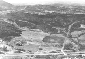 Aerial view of site that would become the main campus of Lane Community College looking to the west, 1965. The Oak Hill School is in the lower left.