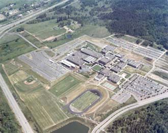 Aerial view of the main campus of Lane Community College looking to the southeast, 1977. The Oak Hill School, formerly the Gonyea home and the Haskell farm, is in the upper center of the photo.