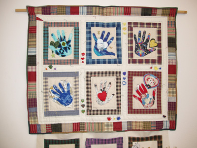 'Heart and Hand Quilts' by Jill McKenney The Heart and Hand Quilts were made in memory of Joan Thomas, a Mathematics instructor who died of breast cancer in 2001. The hearts and hands on the quilts are symbols of caring and helping. The hands included in the quilts include those of her husband, daughter, and Mathematics staff and instructors.