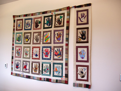 'Heart and Hand Quilts' by Jill McKenney The Heart and Hand Quilts were made in memory of Joan Thomas, a Mathematics instructor who died of breast cancer in 2001. The hearts and hands on the quilts are symbols of caring and helping. The hands included in the quilts include those of her husband, daughter, and Mathematics staff and instructors.