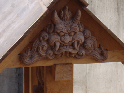 'Long Life' by Yoshiki Kawada, Shimada Mineo and students - Detail of carving on roof Students in Lee Imonen's site-specific sculpture class worked with two master woodcarvers from Japan to create a large, two-sided mahogany relief panel titled, "Long Life."