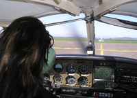 Over the shoulder view of someone flying a plane and about to take off