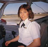Woman sitting in plane cockpit