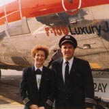 Man and woman standing in front of a plane