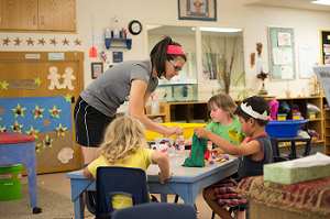Assistant teacher and students working on an activity