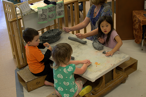 children work with clay at table