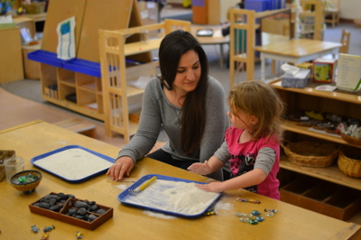 child and ece student at activity table