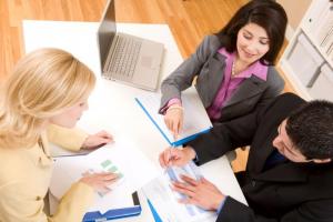 women sitting at a table conducting a business meeting