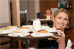 Student carrying out soup to serve for event