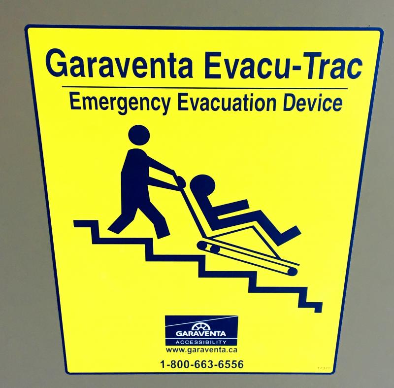 Image of sign for an evacu trac, an emergency carrier for individuals with mobility limitations.