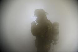 Fire fighter in smoke filled room