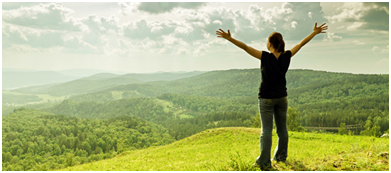 woman embracing life standing in field