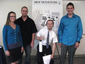 Four honors students with their poster map of refillable water bottle stations around campus.