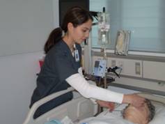 nurse checking on patient bedside
