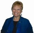 Woman in a blue shirt with short hair smiling
