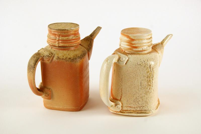 picture of two orangish closed ceramic tea pots