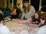 group of people working at a table around a central document