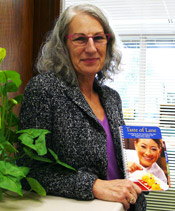 Lane President Mary Spilde with a copy of the "Taste of Lane" cookbook