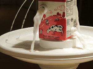 image of “Milk”, a container with multiple spouts, pouring into bowl