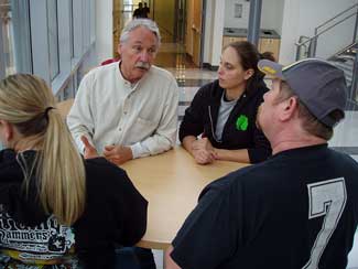 image of four persons around a table
