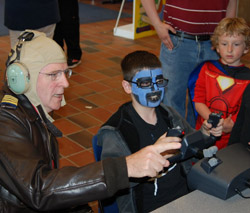 Young superheroes check out the Lane Community College flight simulator with Aviation Academy Director Steve Boulton at Lane Family Day (2011)