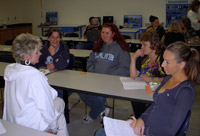 Jeanne Staton (left), president of Staton Companies demolition, sitework and environmental contracting, talks with students in the Women in the Trades reception at Lane Community College on June 12