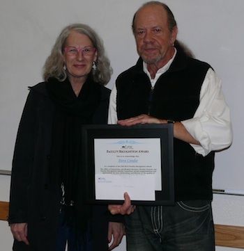 President Mary Spilde presents award to political science instructor Steve Candee