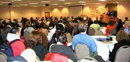 Large group of people sitting at tables during a conference