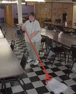 Student Worker mopping floor