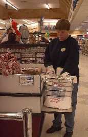 Student Worker bags groceries at Albertsons