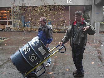 Staff and Student Worker collecting Recylcling Barrel