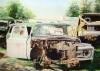 A water color painting of old crushed and rusted cars. Painted with water color, it is 28 x 36 inches