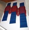 'Denouement' by Nancy Arthur Hoskins - a Woven fabric, wool installation. Three rectangular blue pieces with a red piece draped over all three 